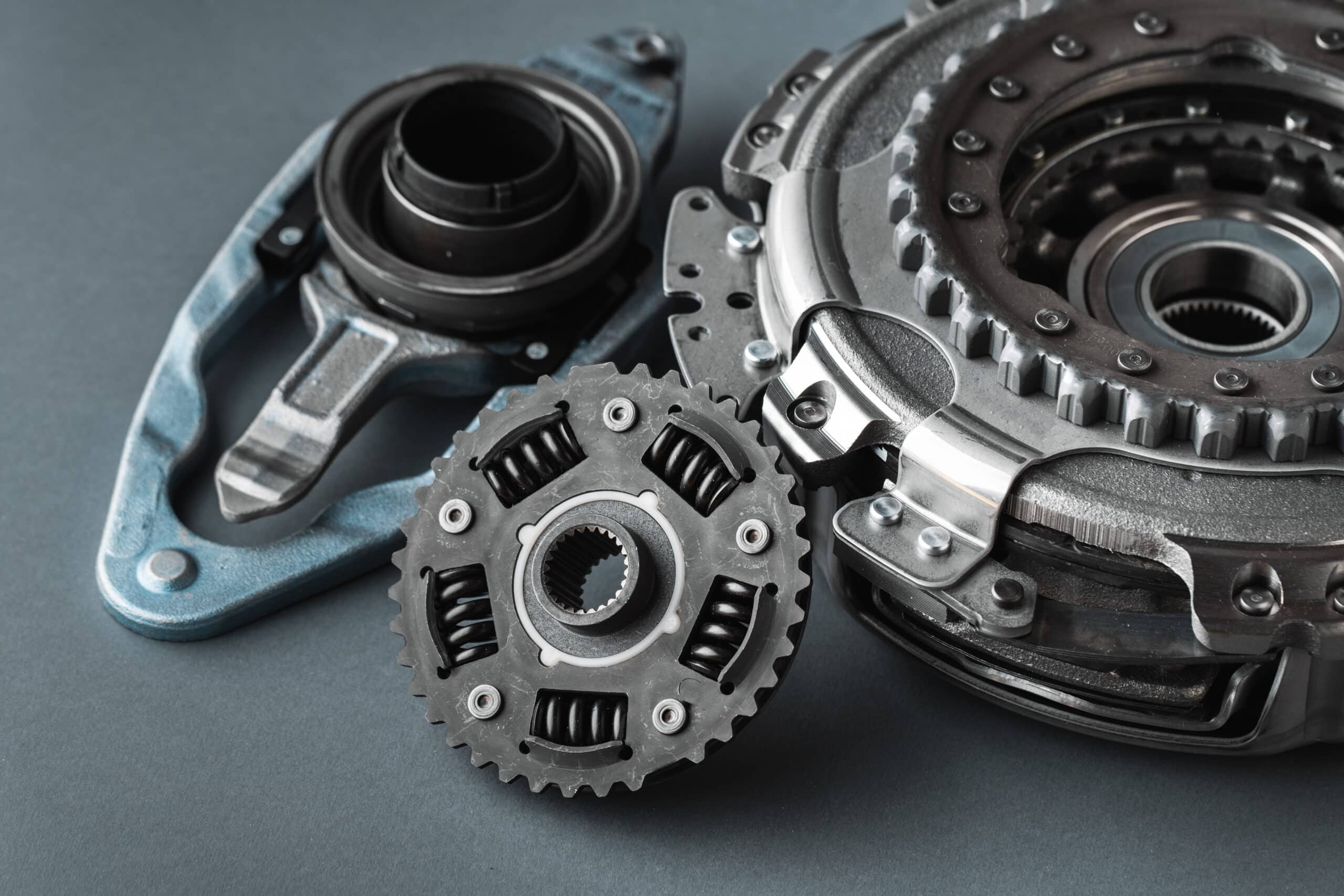 New clutch kit of the automatic gearbox DSG prepared to replace. Spare parts for a modern car isolated on grey background. Car repair and service concept